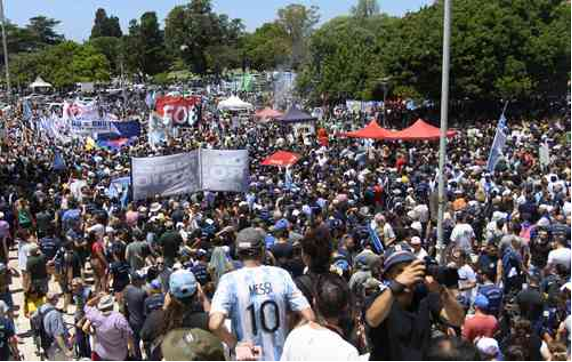 Una gran multitud de personas paradas en un parque.