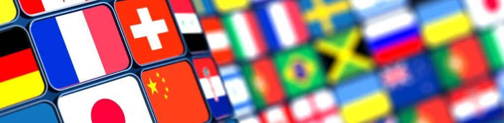 Colección de varias banderas nacionales, que simbolizan Acuerdos Comerciales Internacionales, dispuestas en una cuadrÃcula con poca profundidad de campo.