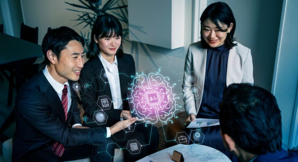 Cuatro profesionales se sientan alrededor de una mesa discutiendo sobre Inteligencia Artificial, con grÃ¡ficos hologrÃ¡ficos de un cerebro e iconos digitales superpuestos entre ellos.
